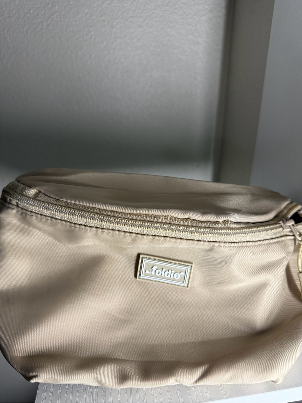 the Foldie Cream Crossbody Bag